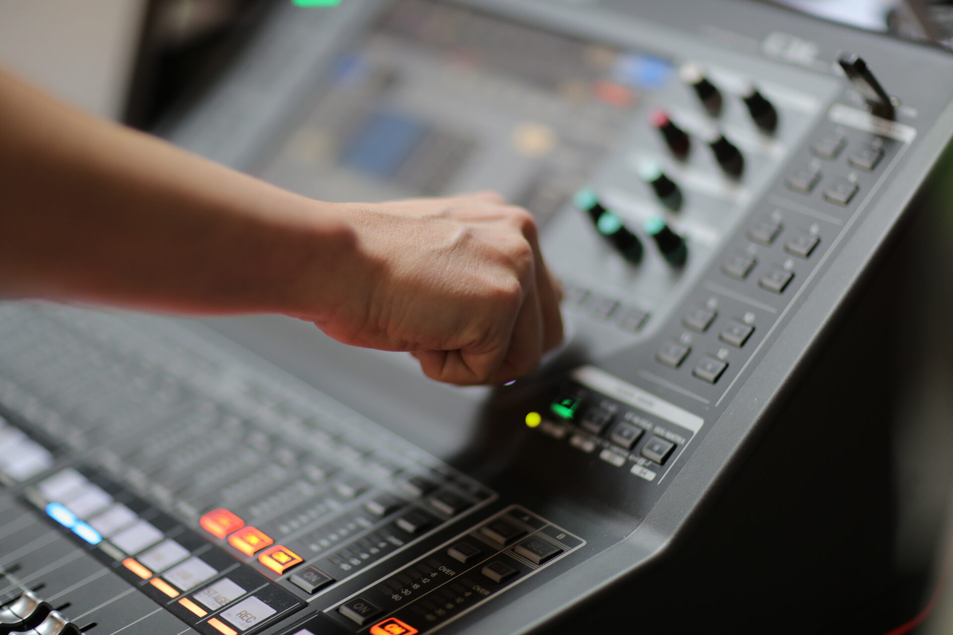 A fist is shown hitting a mixing board.