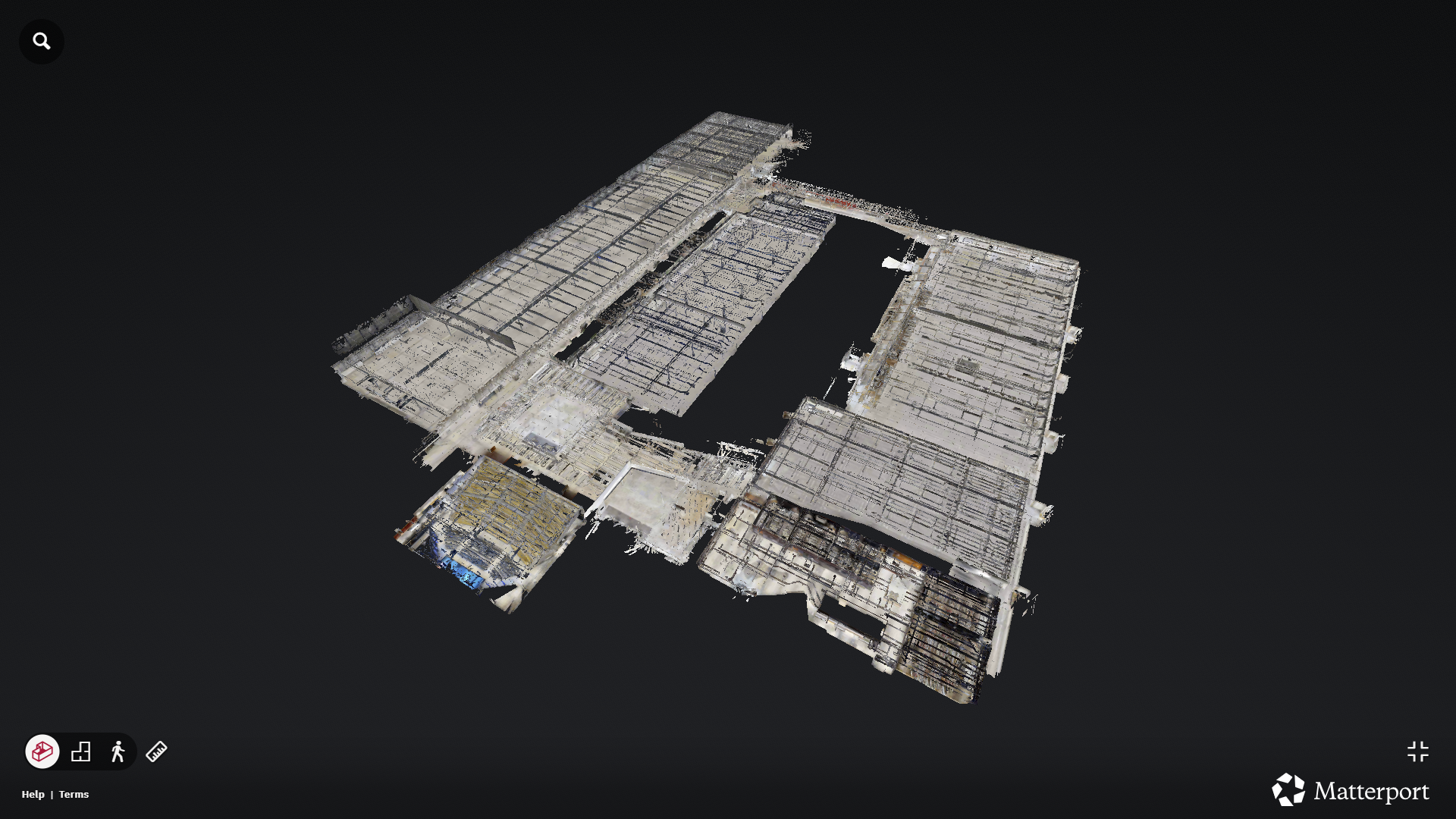 A 3D digital model of a large, multi-section industrial or warehouse building shown from an angled aerial view on a dark background, created using Matterport software.