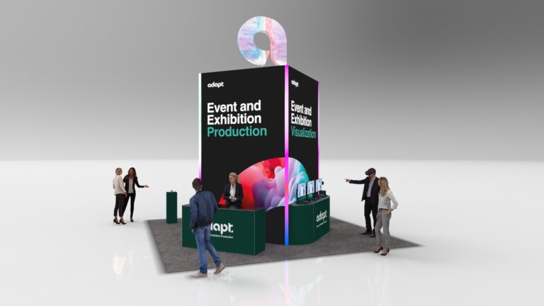 A trade show booth with Event and Exhibition Production and Event and Exhibition Visualization signage. People are talking around the booth, which has monitors, a counter, and a colorful circular display on top.