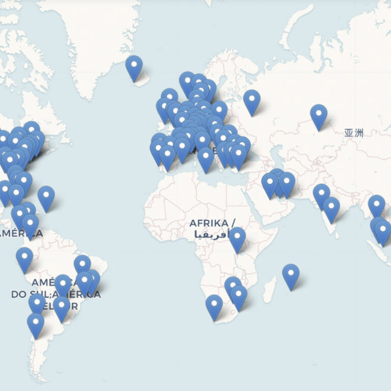 A world map with numerous blue location pins clustered in Europe, a few in Africa, Asia, and the Americas. The continents are labeled in different languages.