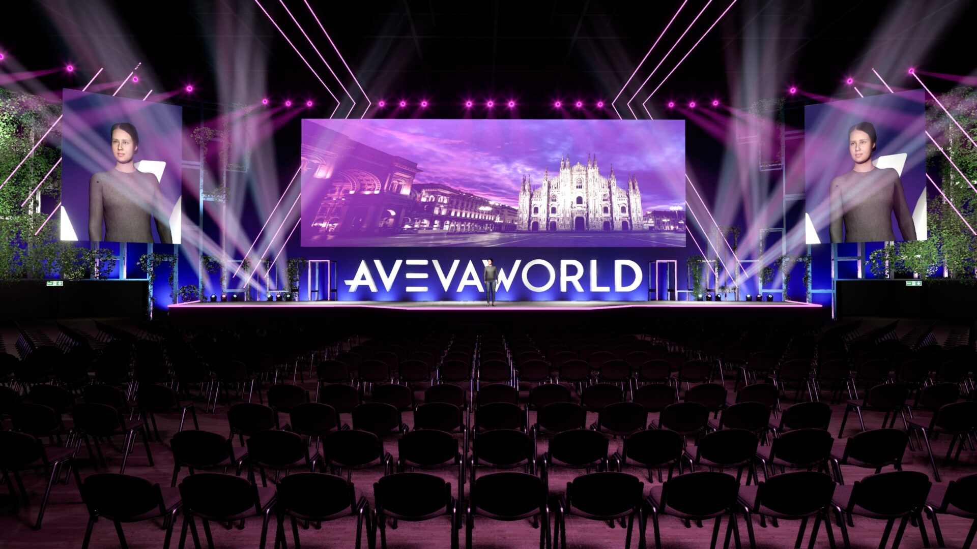 A stage with a large screen displaying AVEVA WORLD and images of Milan Cathedral and avatars. Rows of empty chairs are in the foreground.