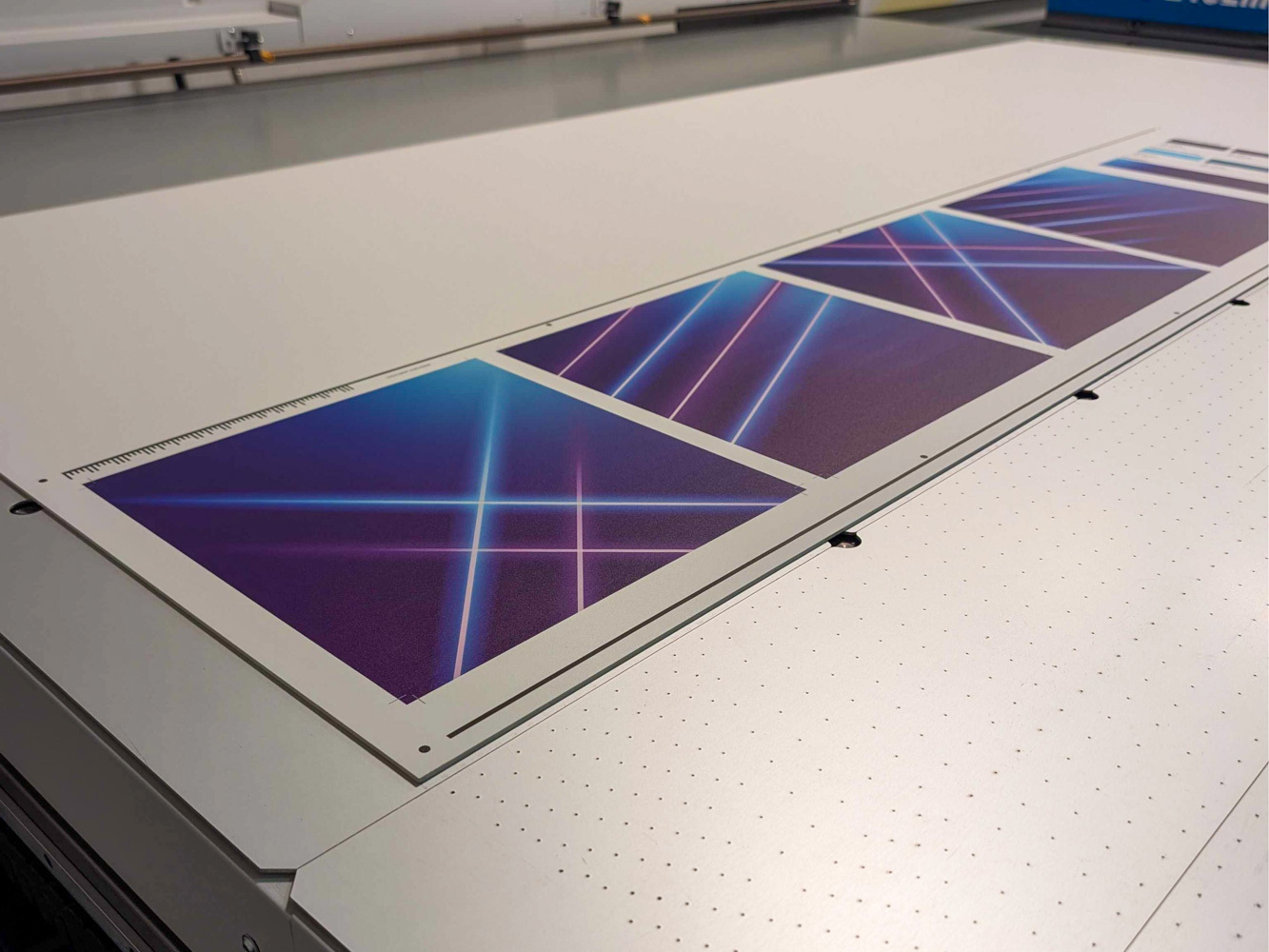 A large printer produces sheets with neon lines in blue, purple, and pink hues. The printed designs feature intersecting glowing lines on a dark background.