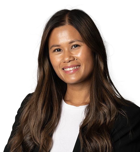 A smiling woman with long brown hair wearing a black blazer over a white shirt.